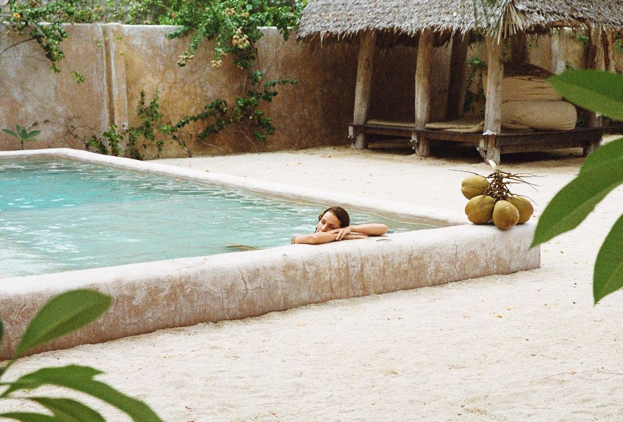 woman relaxing in a pool wearing sustainable swimwear from luxury brand Koraru