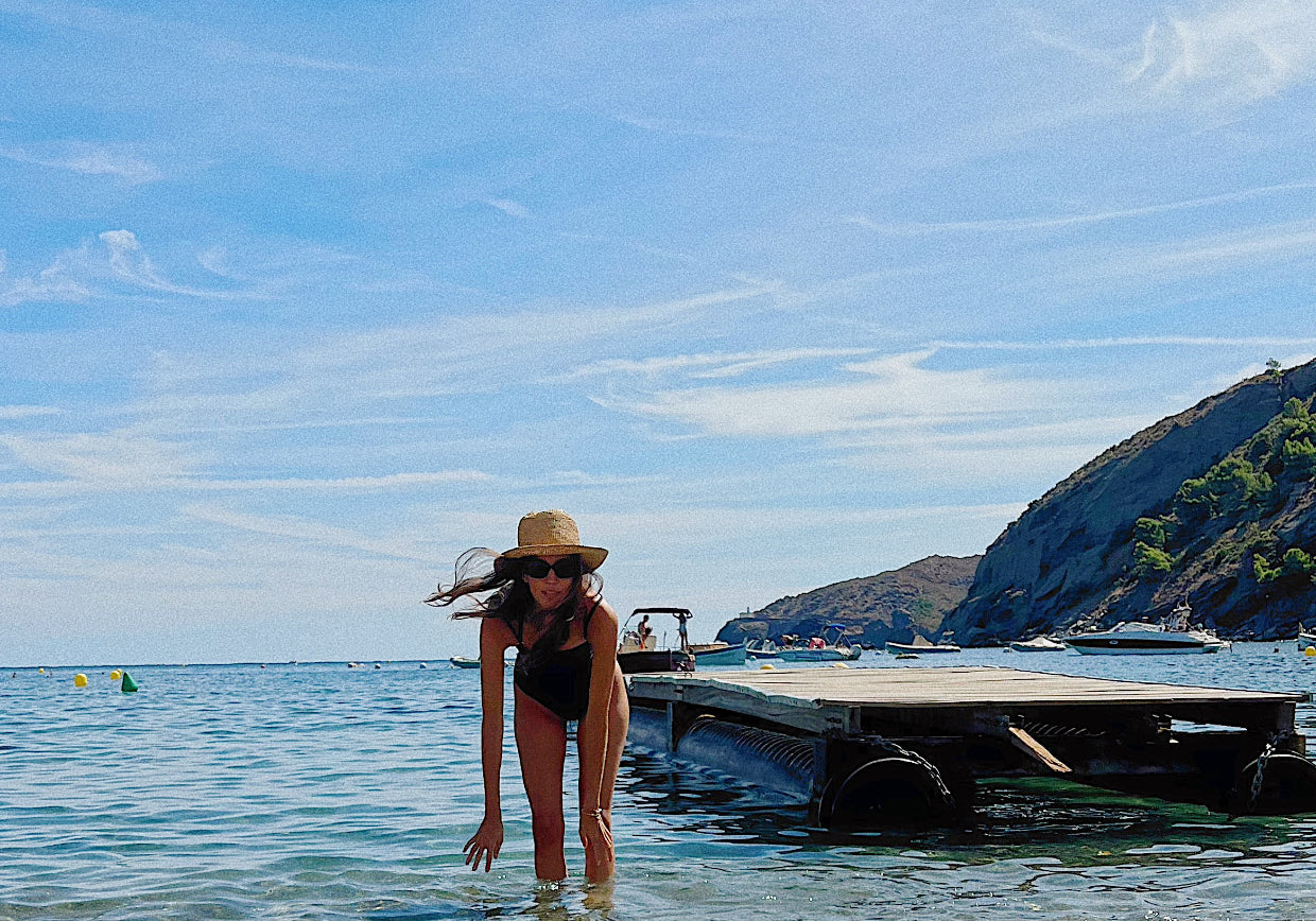 woman standing in the sea wearing Koraru swimwear luxury brand slow fashion 