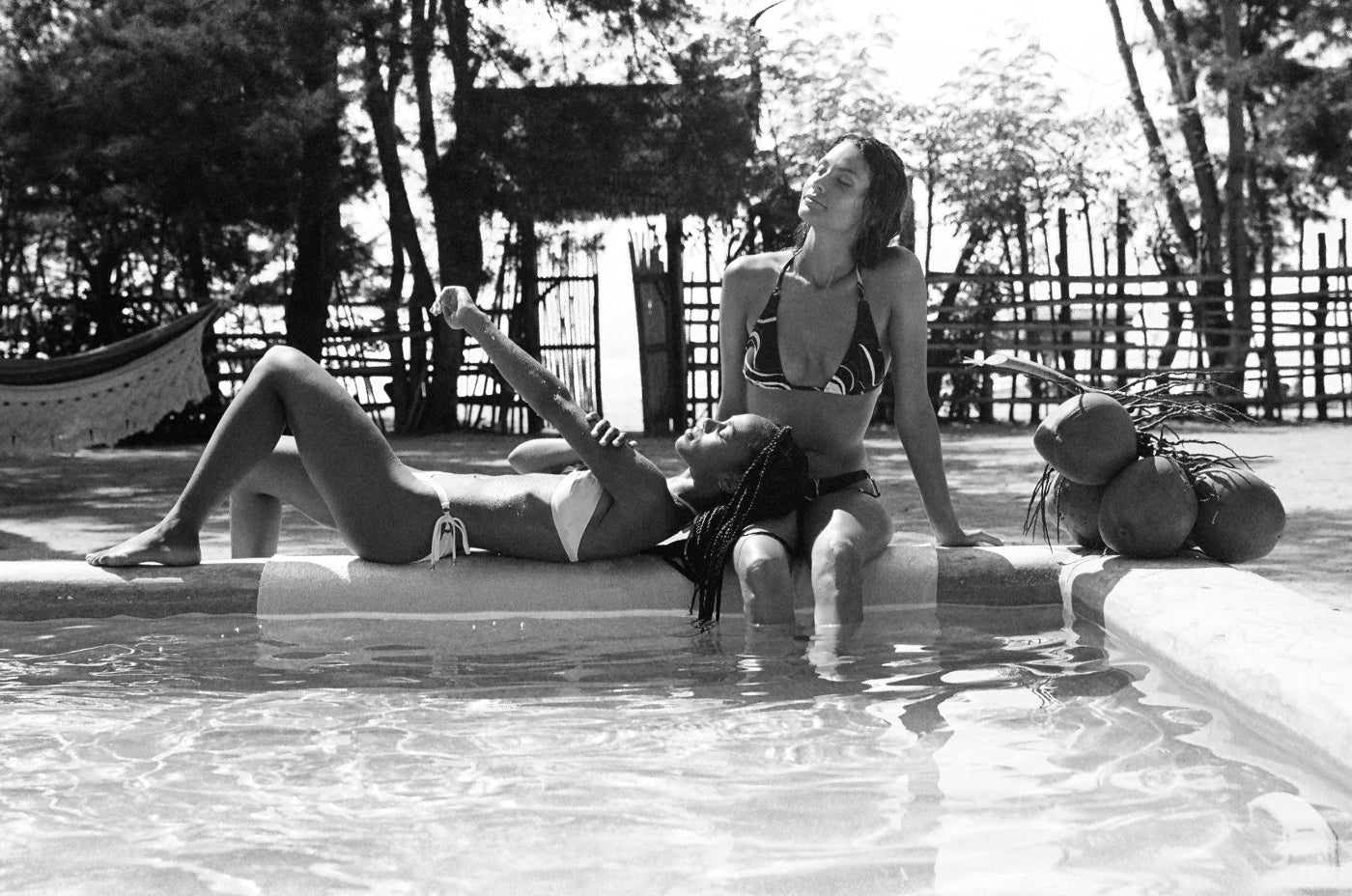 Wearing pink and print bikinis by the pool in Bali made by sustainable swimwear brand Koraru