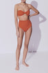 Our scrunch bottoms bikini in orange color are made with econyl swimwear fabric. Econyl fabric is a sustainable swim fabric. Our bandeau top has removable straps and it is in a neutral color. Enjoy luxury swimwear from Koraru swimwear