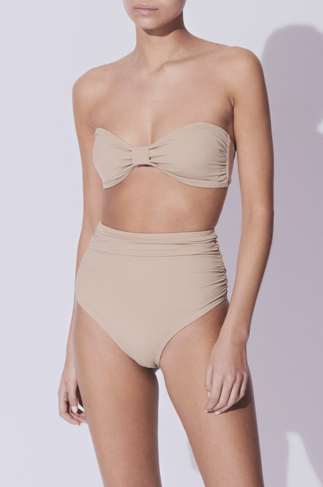 Koraru is the best swimwear brand for eco friendly swimwear and sustainable bikinis. We make vacation swimwear that you can wear in greece. Enjoy our nikko two piece bikini set with high waist bottoms and bandeau bra on a beach in greece or by the pool in ibiza. Wear our european style swimwear on any exotic vacation