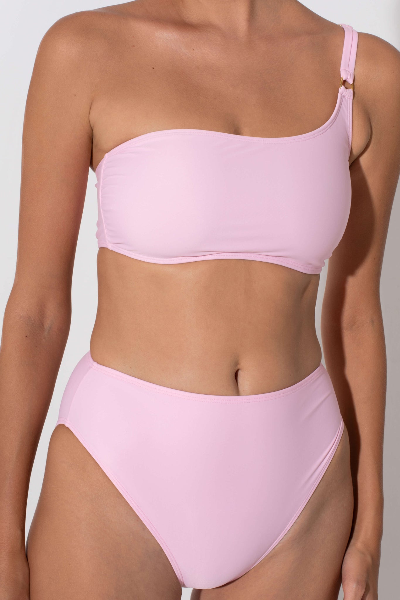 Pink high waist bottoms that are flattering and make legs longer. Shop sustainable swimwear for curvy women