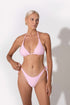 wearing low cut waist bikini bottoms in pink color from Koraru, feminine and flattering swimwear 
