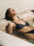Hedy triangle bikini top in black from luxury sustainable swimwear brand Koraru bikinis to relax in