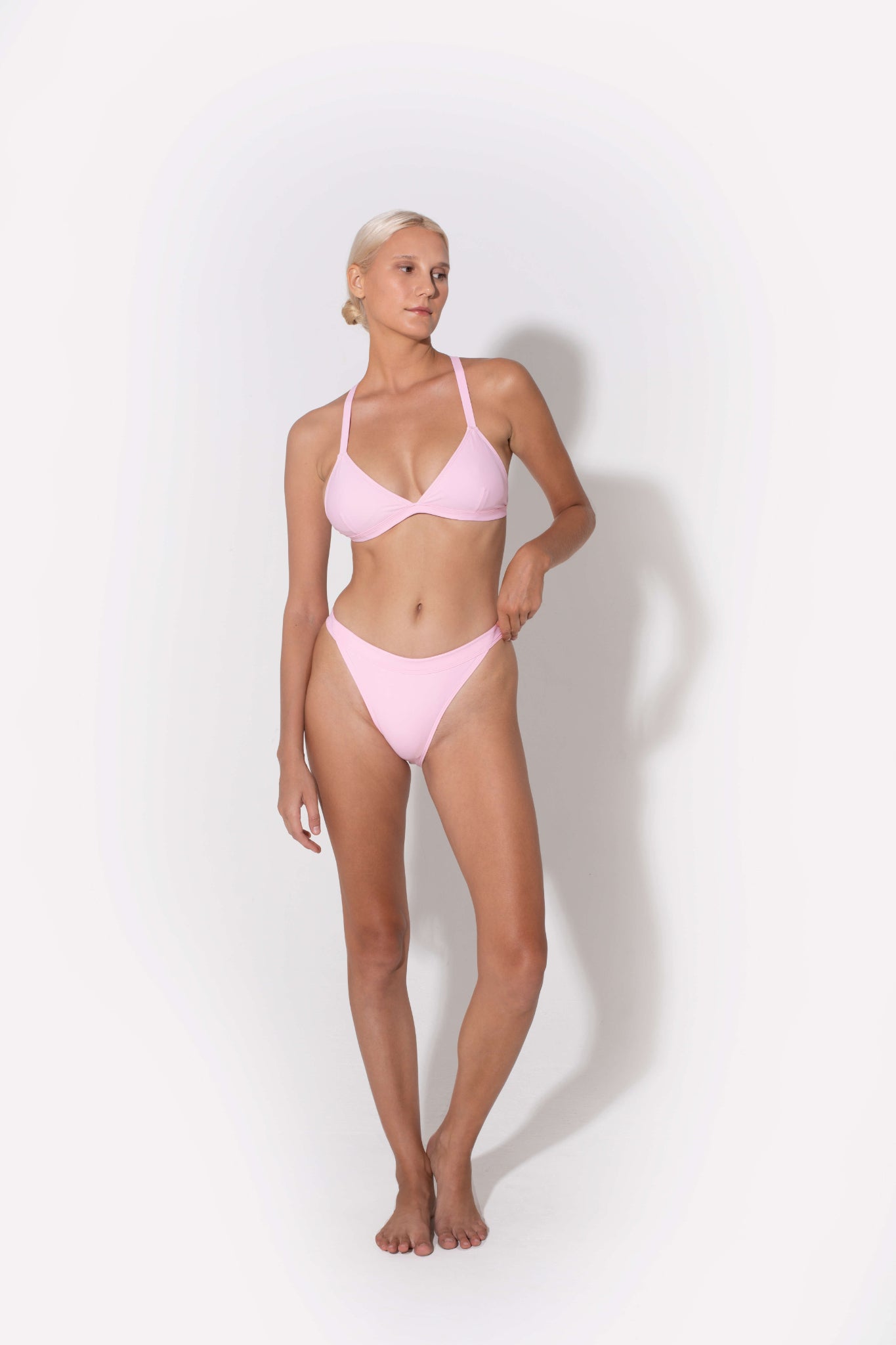 Hedy mid rise bikini bottoms in pink from luxury sustainable swimwear brand Koraru swimsuit bottom pink